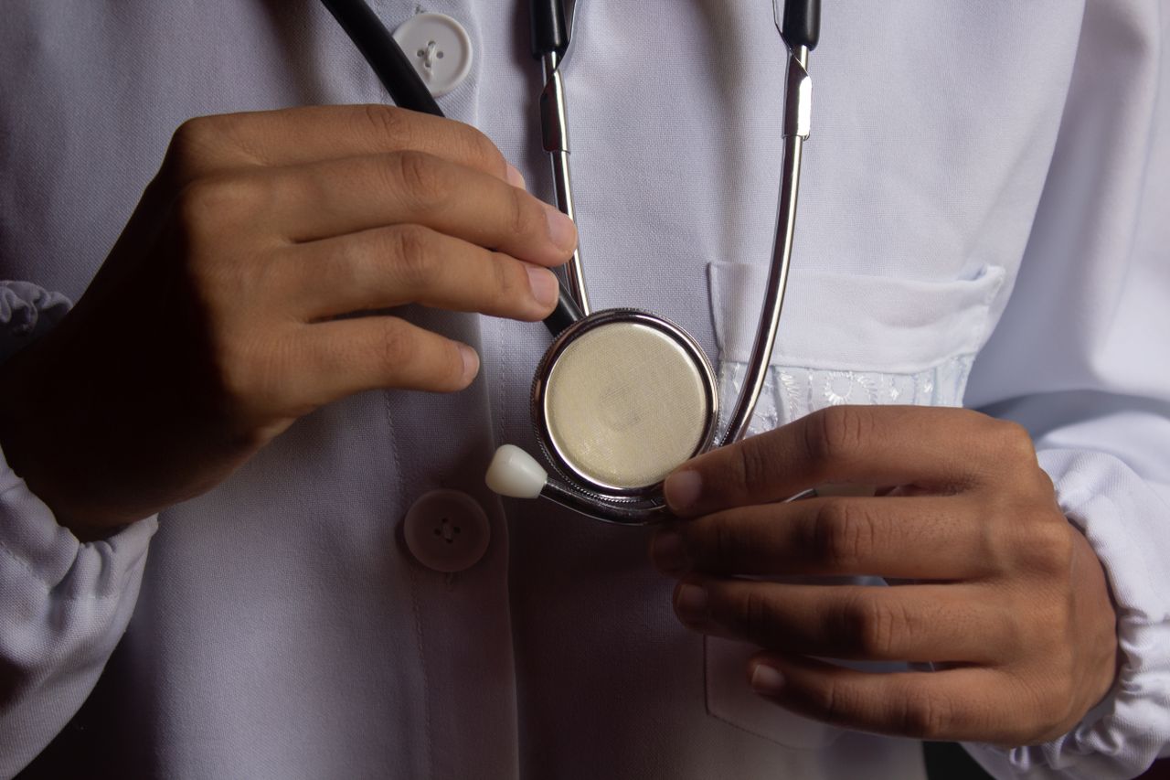About A close-up image showing a doctor holding a stethoscope, symbolizing healthcare and medical practice.